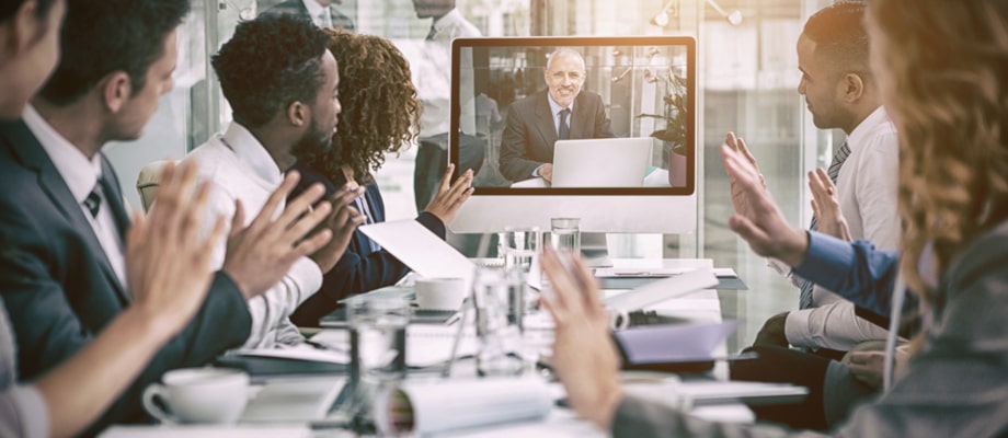 Business people looking at screen during video conference in office